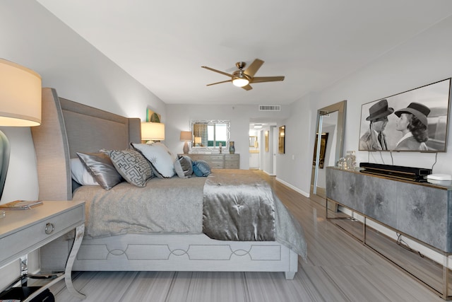 bedroom with hardwood / wood-style flooring and ceiling fan