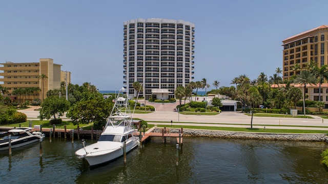 dock area featuring a water view and a lawn