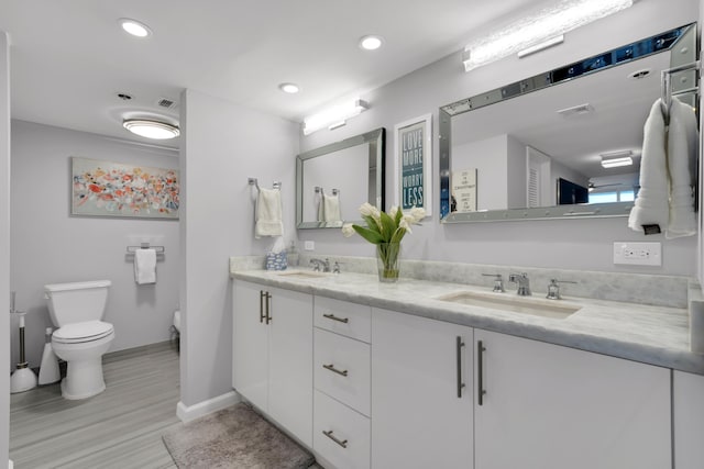 bathroom featuring hardwood / wood-style flooring, vanity, and toilet