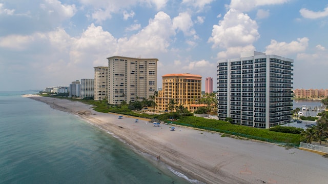 drone / aerial view featuring a water view and a beach view