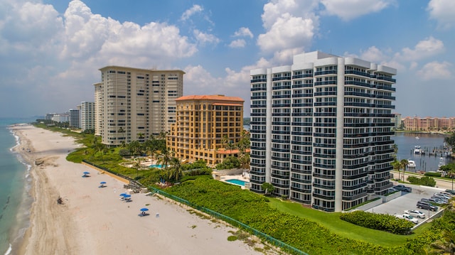 view of property with a beach view and a water view