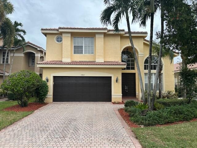 mediterranean / spanish-style home featuring a garage