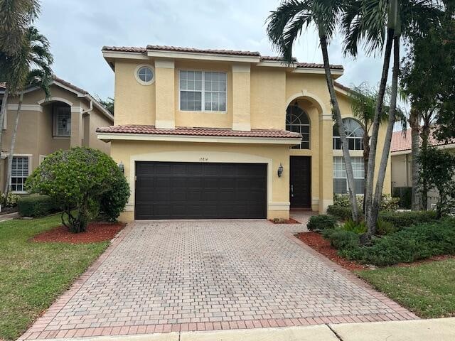 mediterranean / spanish-style home with a garage