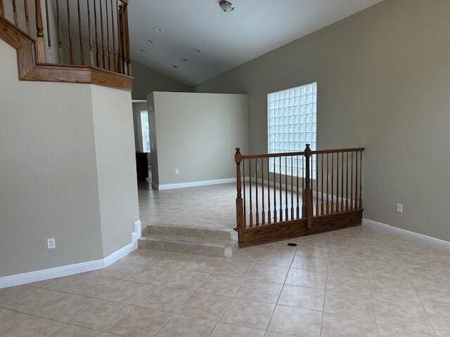 interior space with high vaulted ceiling and tile patterned floors