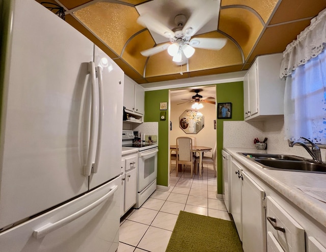 kitchen featuring sink, ceiling fan, light tile patterned flooring, white cabinetry, and white appliances