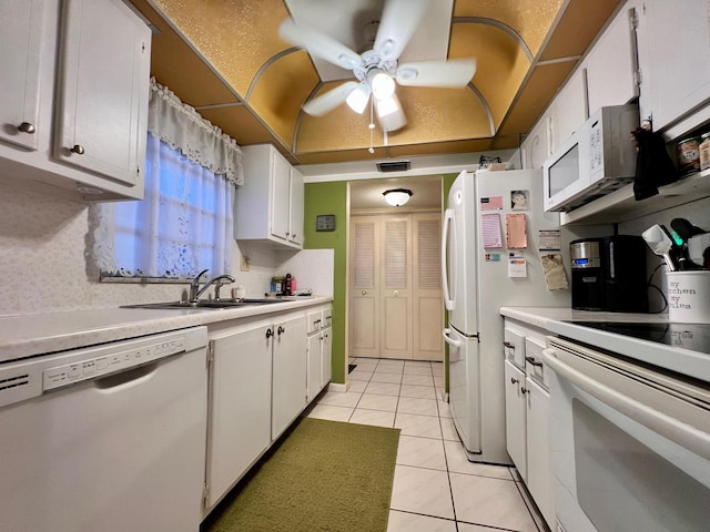 kitchen featuring light tile patterned flooring, sink, ceiling fan, white appliances, and white cabinets