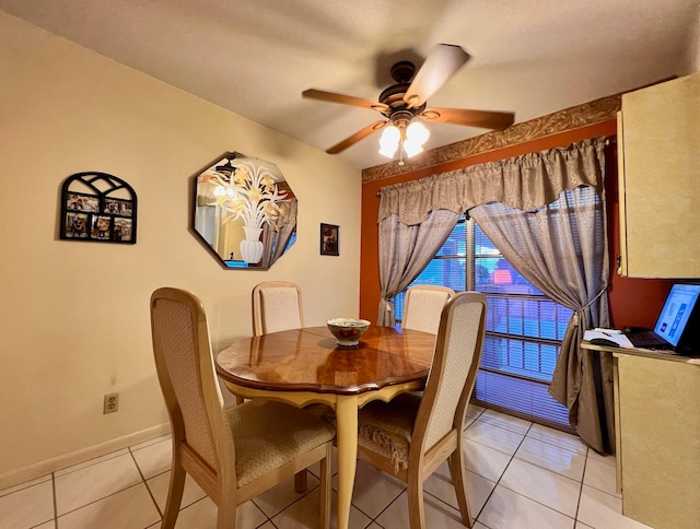 dining area featuring light tile patterned floors and ceiling fan