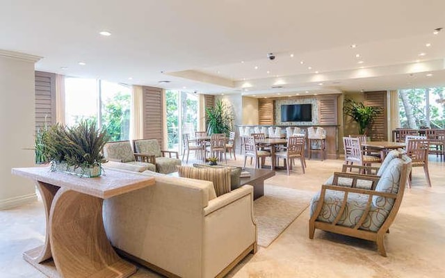 living room with floor to ceiling windows and a tray ceiling