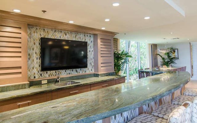 bar with sink and stone counters