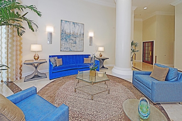 living room featuring crown molding and ornate columns