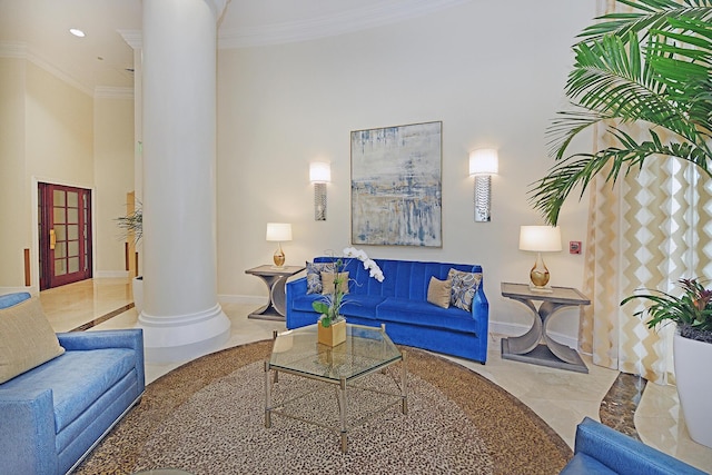 living room with ornate columns and ornamental molding