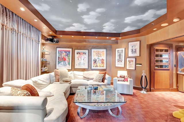 living room with a tray ceiling and light carpet