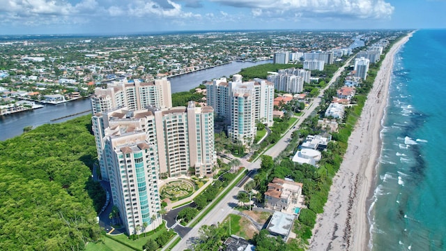 drone / aerial view with a water view and a beach view