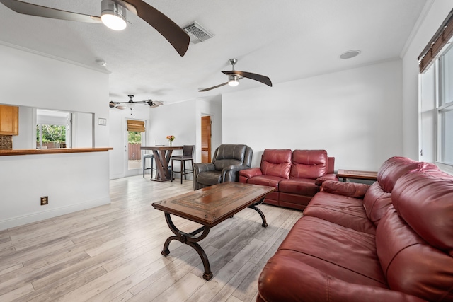 living room featuring ornamental molding and light wood-type flooring