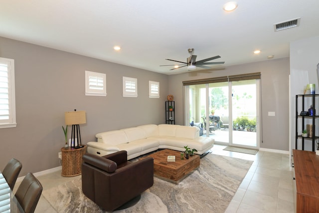 living room featuring light tile patterned floors and ceiling fan