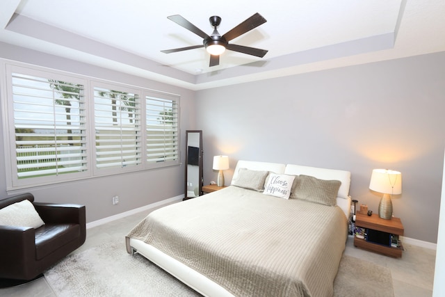 bedroom featuring a tray ceiling and ceiling fan