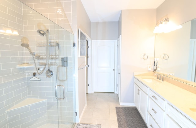 bathroom with vanity, a shower with shower door, and tile patterned floors