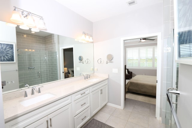 bathroom featuring vanity, tile patterned floors, and a shower with shower door