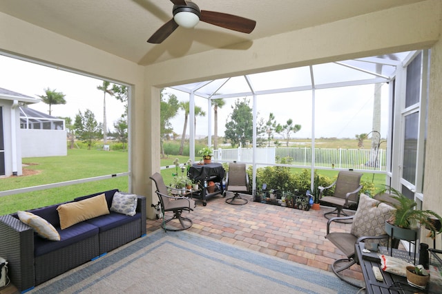 sunroom / solarium with plenty of natural light and ceiling fan