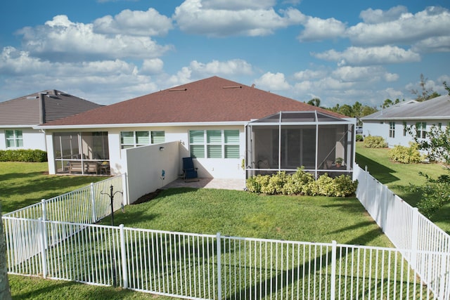 back of house with a sunroom and a yard