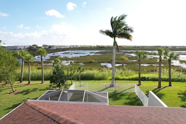 view of community with a water view and a yard