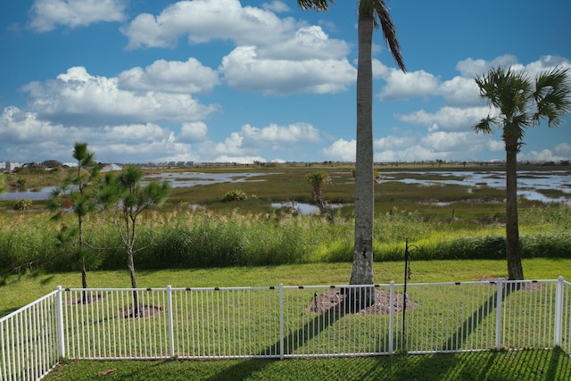 view of yard with a water view and a rural view