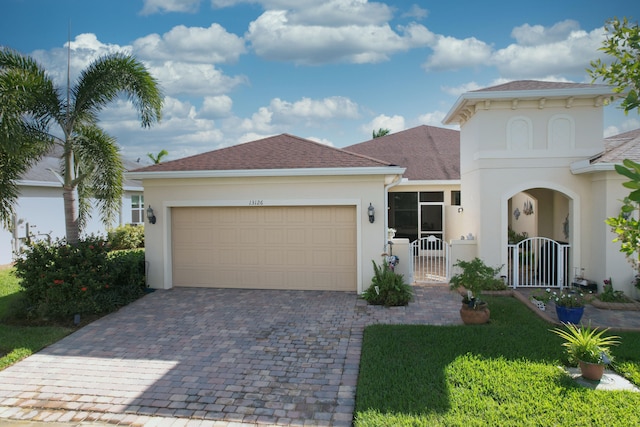 view of front facade with a garage and a front yard