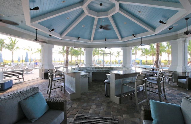 view of patio / terrace with an outdoor wet bar, ceiling fan, and a gazebo