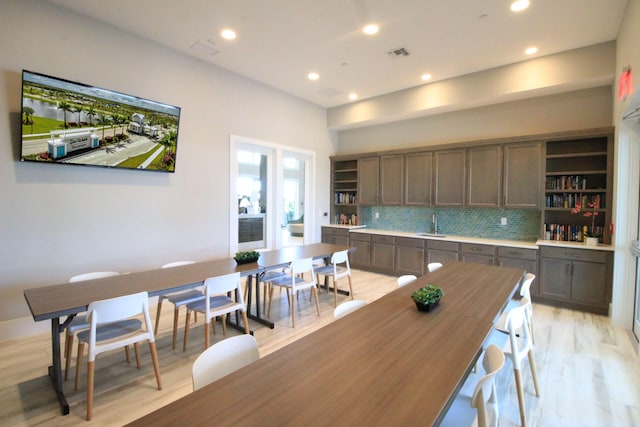 kitchen featuring tasteful backsplash, sink, and light hardwood / wood-style floors