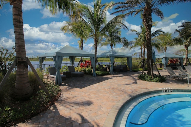 view of swimming pool featuring a patio and a gazebo