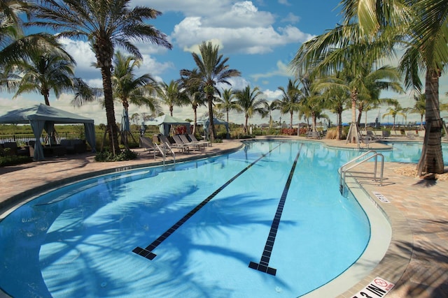 view of swimming pool featuring a patio and a gazebo