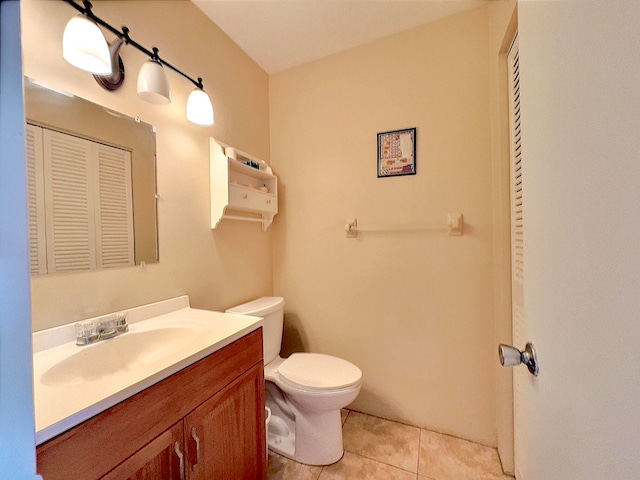 bathroom featuring tile patterned floors, vanity, and toilet