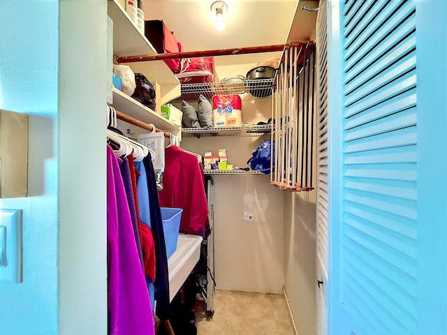 spacious closet featuring light tile patterned flooring