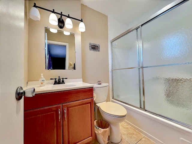 full bathroom featuring tile patterned flooring, vanity, bath / shower combo with glass door, and toilet