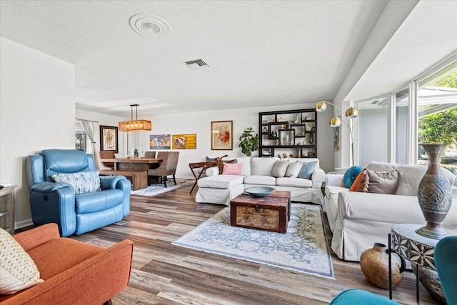 living room featuring a textured ceiling and hardwood / wood-style flooring