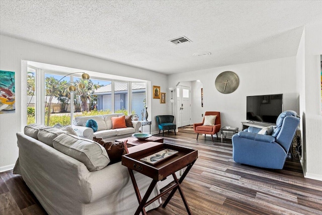 living room featuring hardwood / wood-style floors and a textured ceiling