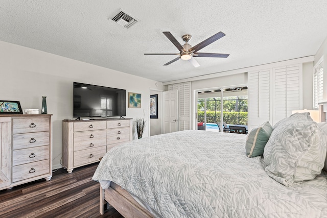 bedroom featuring a textured ceiling, access to outside, dark wood-type flooring, and ceiling fan