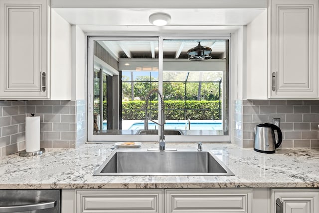 kitchen with plenty of natural light, sink, and white cabinetry