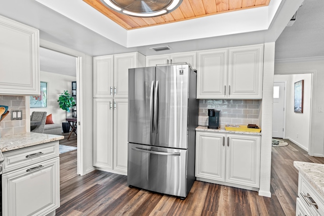 kitchen featuring white cabinets, dark hardwood / wood-style flooring, and stainless steel fridge