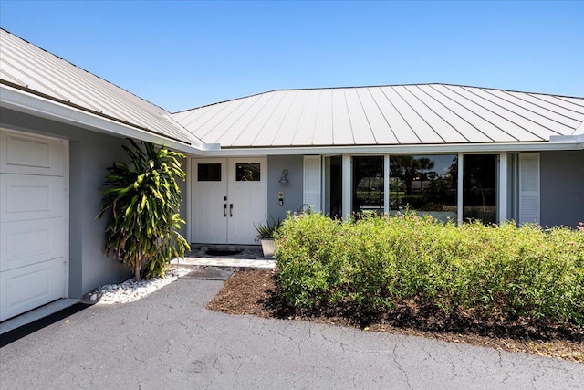 view of exterior entry featuring a garage