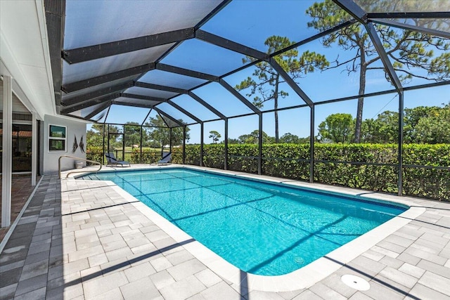 view of swimming pool with a lanai and a patio