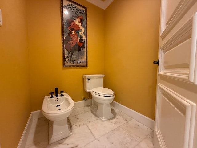 bathroom with toilet, ornamental molding, and a bidet