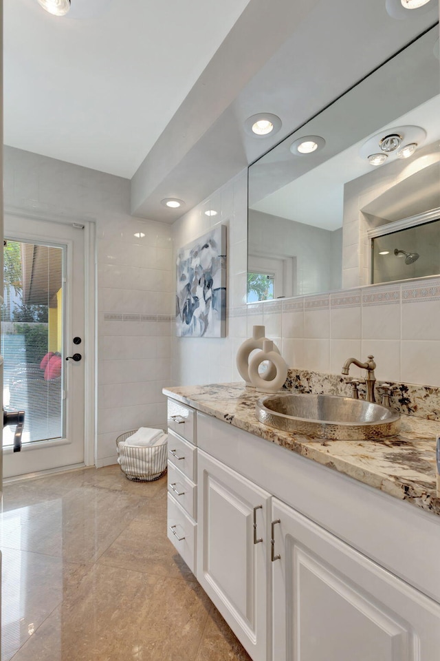 bathroom featuring backsplash, tile walls, and a wealth of natural light