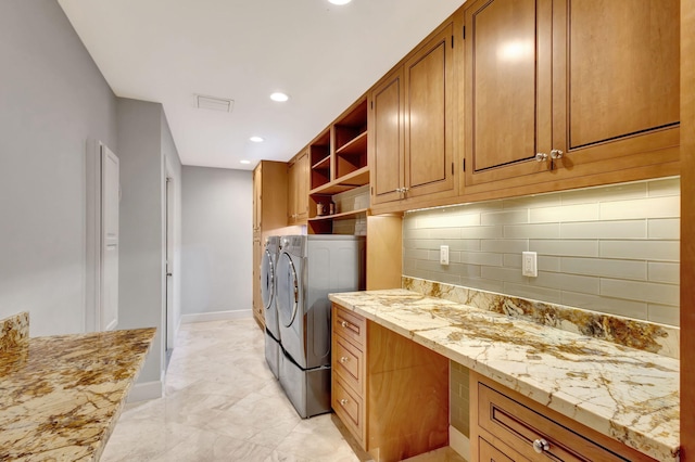 washroom featuring cabinets and separate washer and dryer