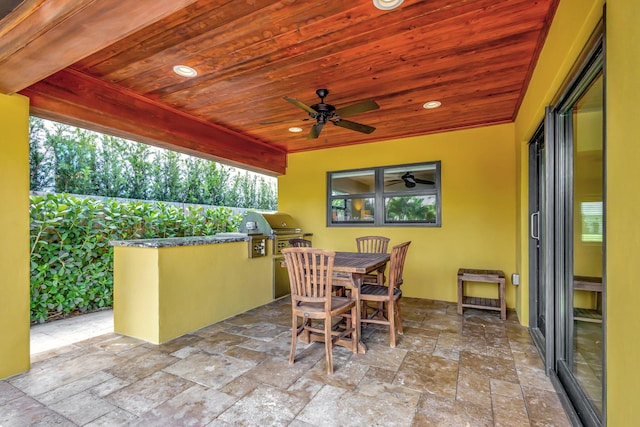 view of patio featuring area for grilling, ceiling fan, and a grill