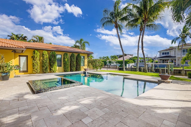 view of swimming pool with an in ground hot tub and a patio