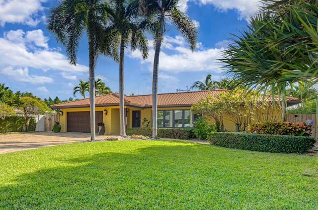 single story home with a garage and a front lawn