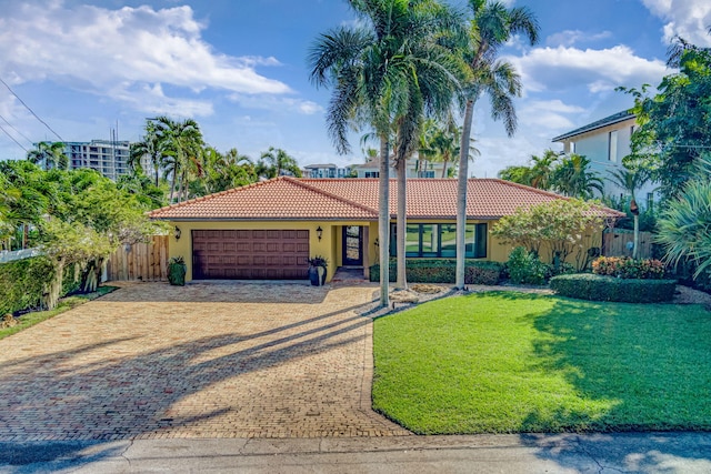 view of front of home with a garage and a front yard