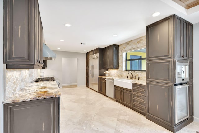 kitchen featuring exhaust hood, sink, decorative backsplash, appliances with stainless steel finishes, and dark brown cabinetry