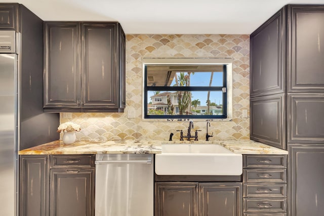 bar with decorative backsplash, sink, dark brown cabinets, and appliances with stainless steel finishes